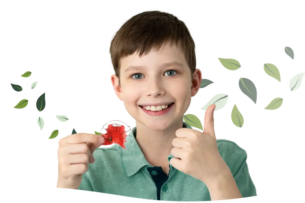 boy holding palatal expander to widen upper jaw