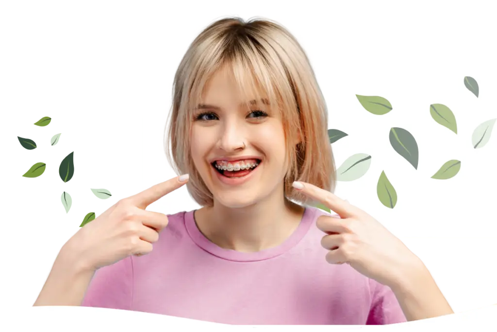 a teen girl pointing at her colorful braces in Oakton